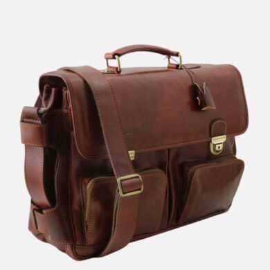 Brown leather briefcase with top handle, adjustable shoulder strap, and front zip pockets with brass hardware.