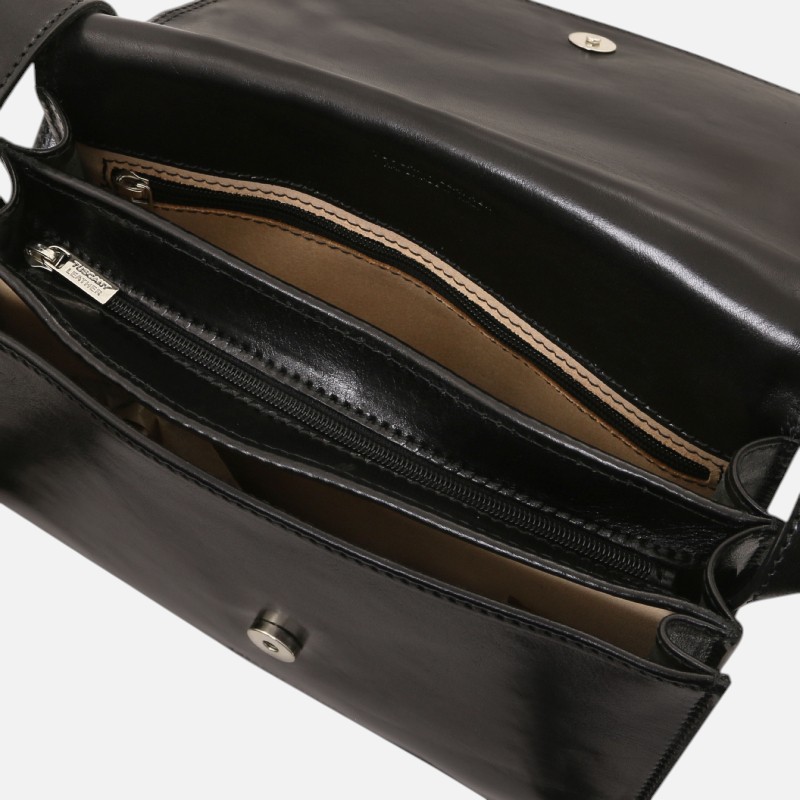 Black leather handbag opened to show multiple inner compartments, including a zip pocket and tan lining.
