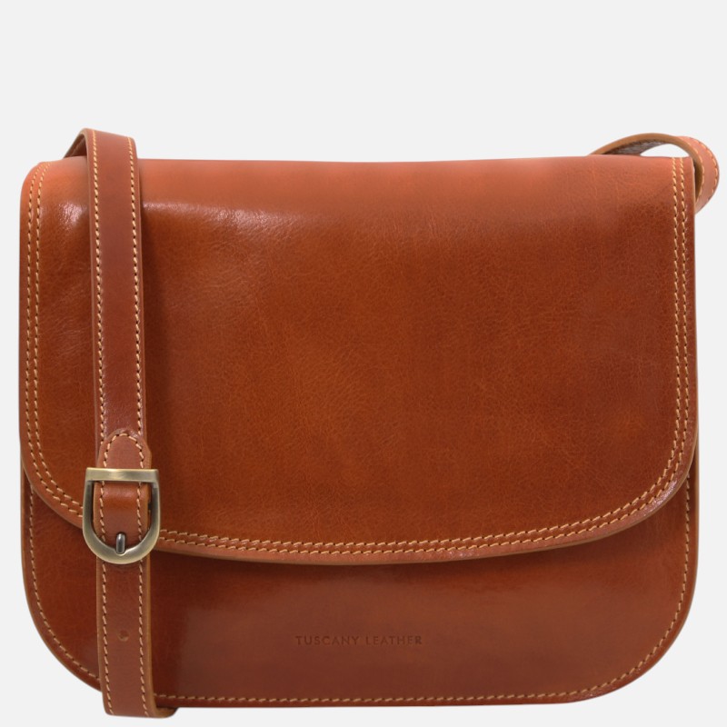 Tan leather crossbody bag with a buckle strap and contrast stitching; brand 'TUSCANY LEATHER' on the front panel.