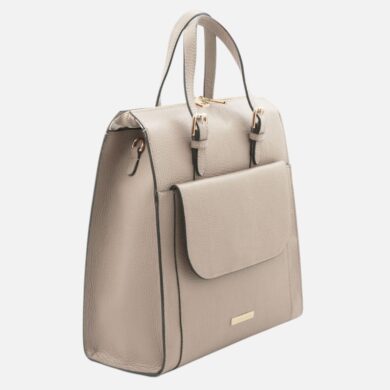 Beige pebbled leather handbag with a front pocket and gold-tone hardware viewed from a slight angle