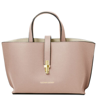 Pink pebble-grain leather tote with two short handles and a central gold clasp closure at the front pocket strap, brand Tuscany Leather visible at bottom.