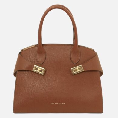 Brown pebbled leather handbag with two top handles and gold-tone buckle straps.