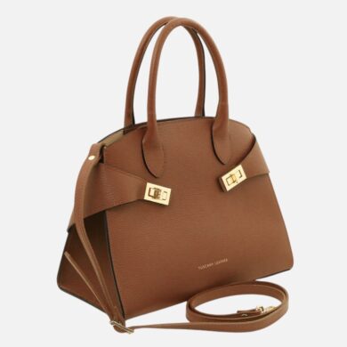 Brown leather handbag with dual top handles, gold clasp straps, and a detachable shoulder strap on a light background.