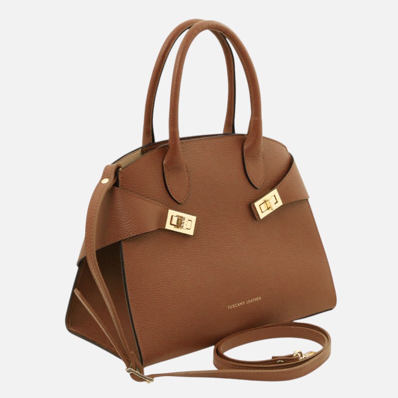 Brown leather handbag with dual top handles, gold clasp straps, and a detachable shoulder strap on a light background.