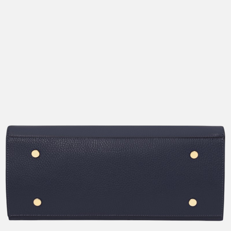 Dark blue pebbled leather wallet laid flat, with four gold-toned studs at the corners (two on each side).”,