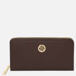Brown textured leather wallet with a gold zipper and circular gold logo on the front