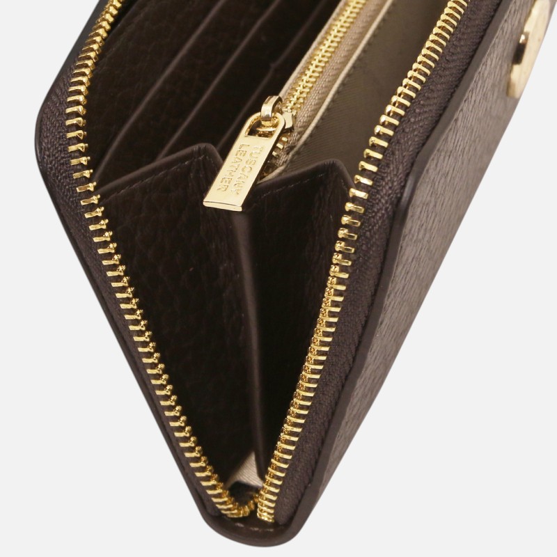 Brown leather zip-around wallet opened to reveal card slots and inner compartments at the center.