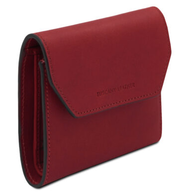 Red compact leather wallet with a fold-over flap and black edge trim, brand name Tuscany Leather visible on the front.