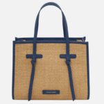 Straw tote bag with blue leather trim and two handles, front view