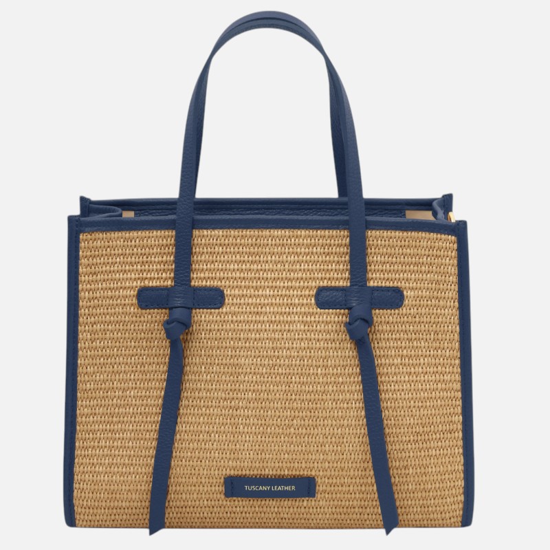 Straw tote bag with blue leather trim and two handles, front view