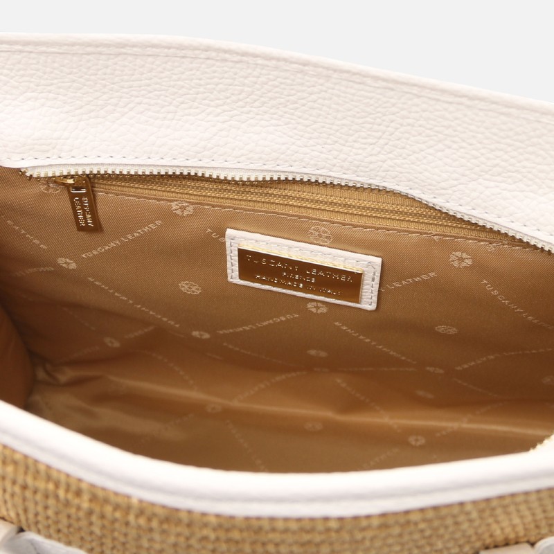 Open white leather bag interior with tan fabric lining, zipper pocket, and brand label.