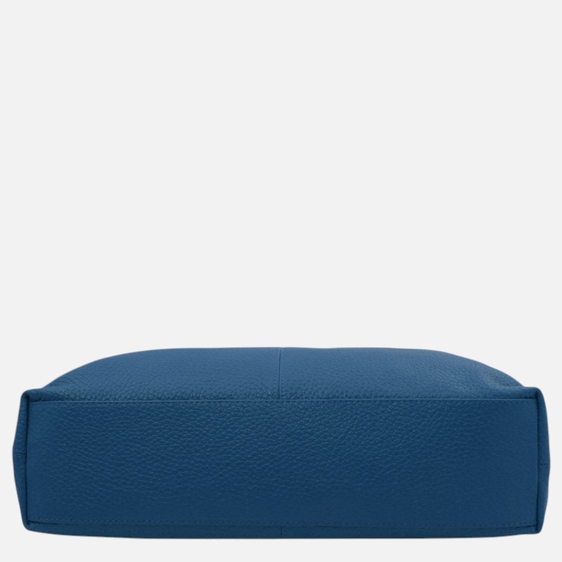 Bottom view of a blue pebbled leather handbag showing the base and side seams.