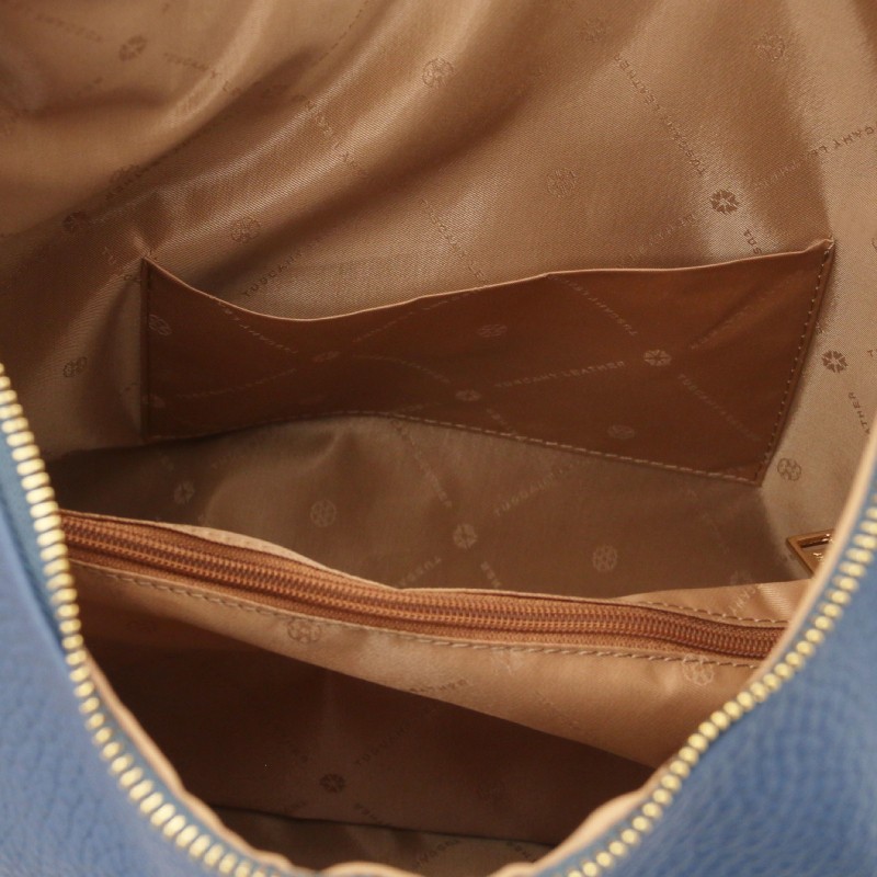 Blue bag interior with a tan lining and a zippered pocket along one side for small items, visible from an open top view.