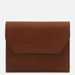 Brown leather wallet with visible stitching and a flap marked Tuscany Leather