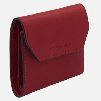 Red compact leather wallet with a fold-over flap and black edge trim, brand name Tuscany Leather visible on the front.