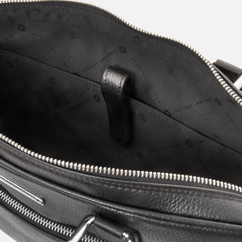 Open black leather handbag showing interior with a leather strap loop and branded lining