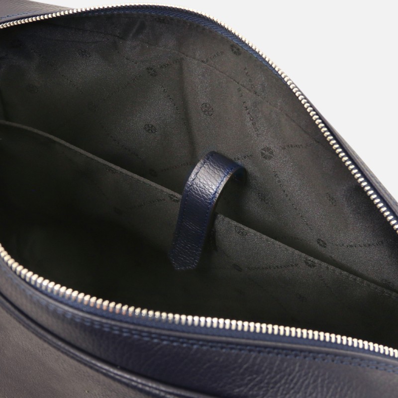 Open navy leather handbag showing interior with a blue inner strap and zippered top edge, dark lining visible.