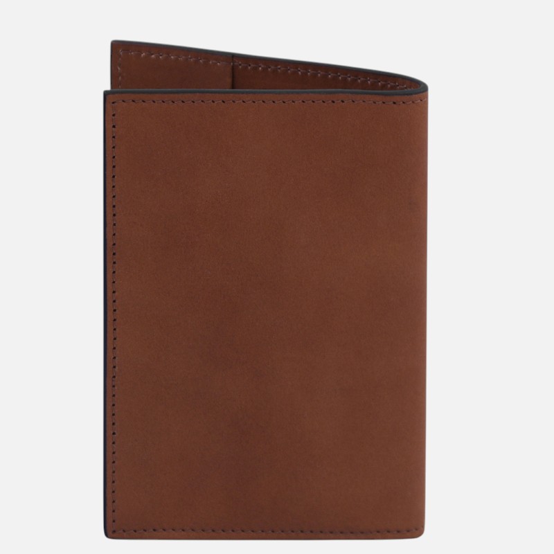 Brown leather wallet with visible stitching along the edges, standing upright against a light background