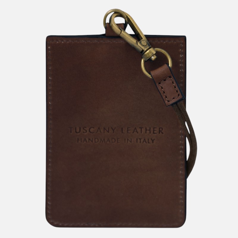 Brown leather cardholder with metal clip and strap, engraved 'Tuscany Leather Handmade in Italy'