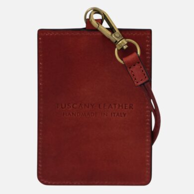 Red leather wallet with brass hardware and attached strap, stamped 'Tuscany Leather Handmade in Italy'