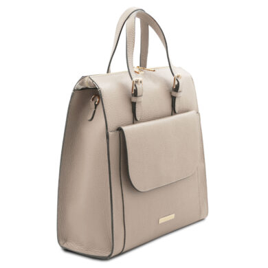 Beige pebbled leather handbag with a front pocket and gold-tone hardware viewed from a slight angle