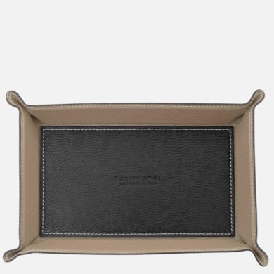 Beige leather tray with a black inner panel and white stitching; stamped 'Tuscany Leather Handmade in Italy'.Keep concise and informative for context.Note: ensure readability.