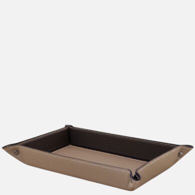 Tan leather rectangular tray with dark brown interior and white stitching, for organizing small items at a desk or dresser.
