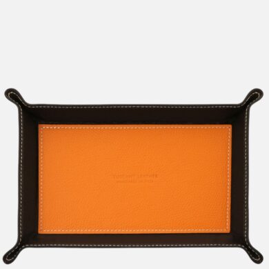 Leather valet tray with an orange inner panel inside a dark brown border and white stitching edge detail.