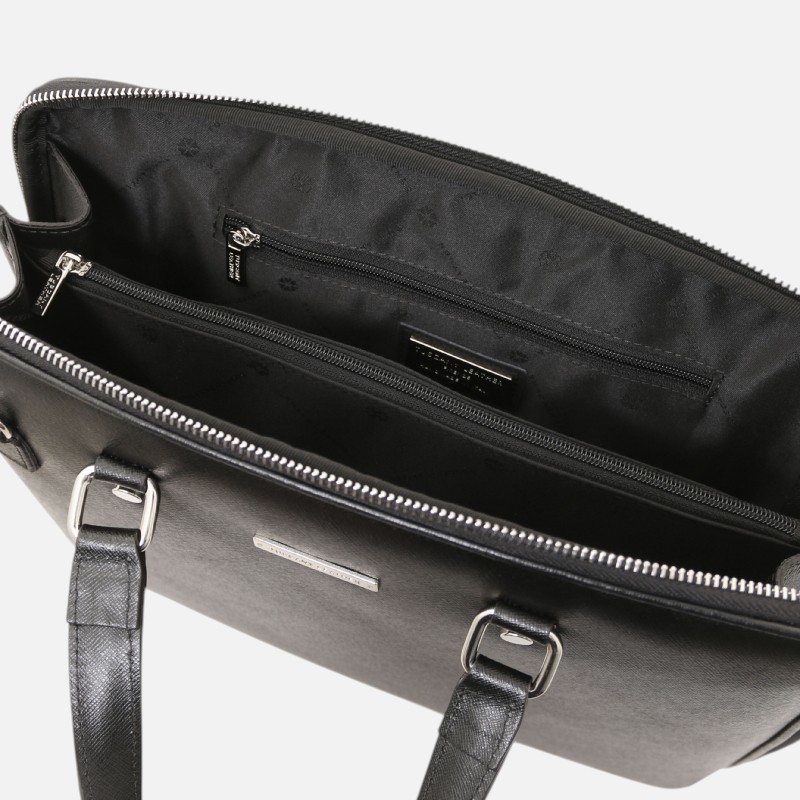 Black handbag opened to reveal inner compartments with two zip pockets and a brand tag on the lining.