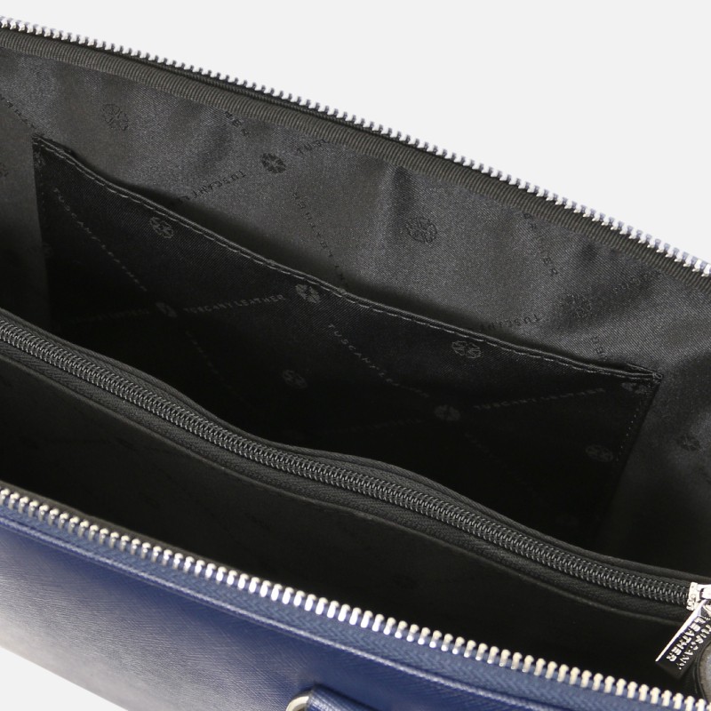 Open blue zippered bag showing dark interior with multiple pockets and a central zip compartment