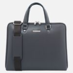 Navy blue leather briefcase with two top handles, a detachable shoulder strap, and silver hardware against a light background.