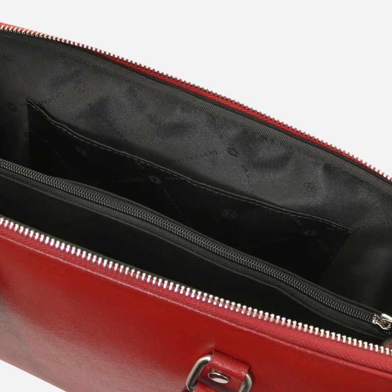 Red leather handbag open to reveal a main compartment, zippered divider, and inner pockets against a black lining.