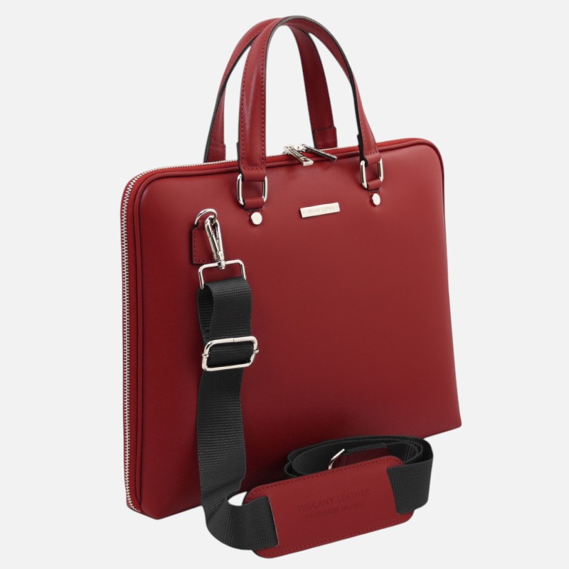Red leather handbag with double handles and a detachable black shoulder strap.