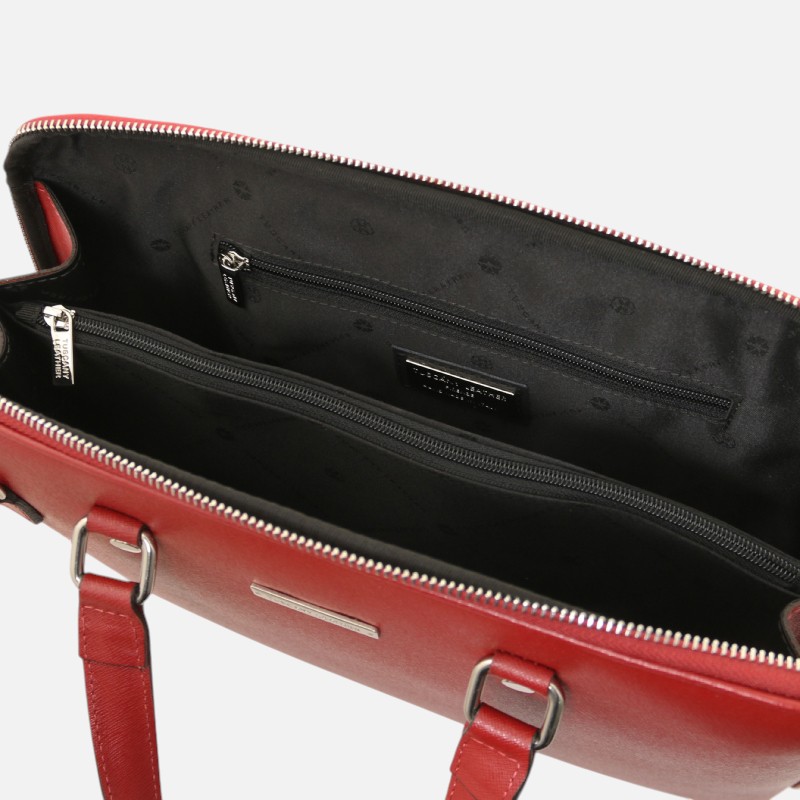 Red leather handbag opened to reveal a black interior with two zippered compartments and a small brand tag inside