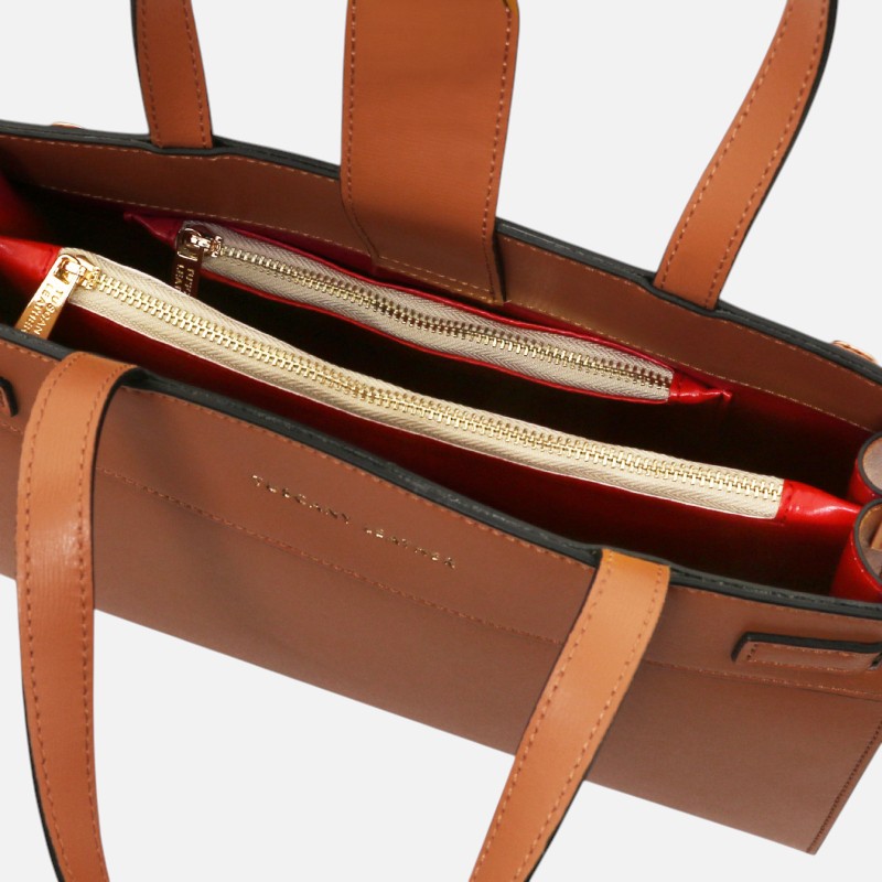 Brown leather handbag opened to show red interior and two gold-zipped compartments for organizers and valuables.
