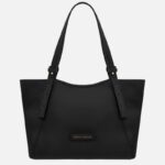 Black leather handbag with two shoulder straps seen from the front, featuring a small brand plaque at the bottom center.