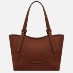 Brown leather tote bag with two shoulder straps and a small front patch label.