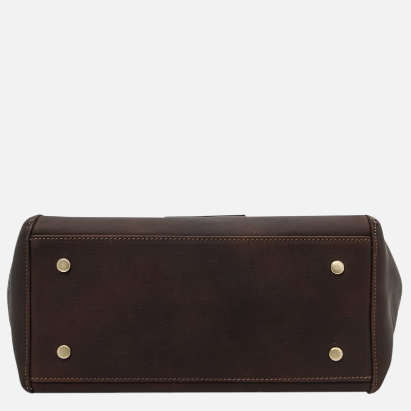 Brown leather bag laid flat viewed from the bottom with four brass foot studs visible on the base.