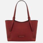 Red leather tote bag with two long straps and a small Tuscany Leather brand patch on the front.