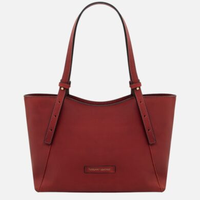 Red leather tote bag with two long straps and a small Tuscany Leather brand patch on the front.