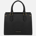 Black handbag with rounded handles and gold hardware, tassel-free, labeled Tuscany Leather at the bottom center.