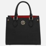 Black pebbled leather handbag with red interior and gold hardware, featuring a circular front logo.