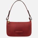 Red leather shoulder bag with a rounded bottom, top zipper, and a gold-toned zipper pull; brand tag reads Tuscany Leather on the front.