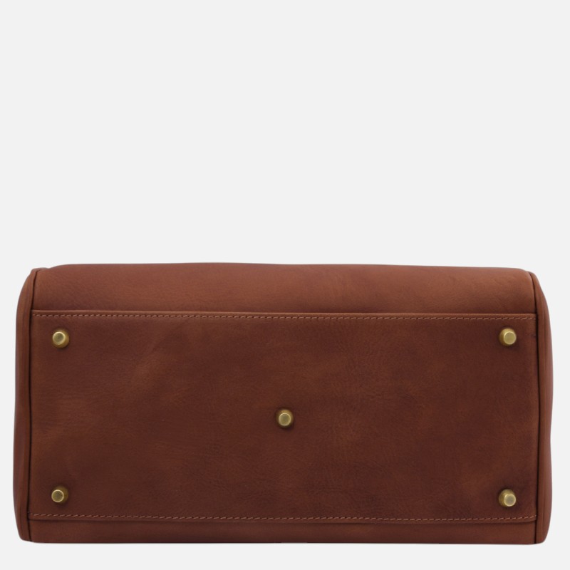 Bottom view of a brown leather handbag with brass feet/studs visible on the base