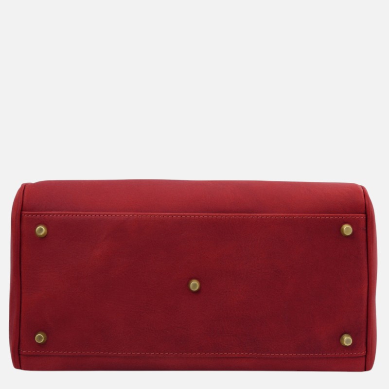 Red leather handbag viewed from the bottom, showing four metal feet and a central stud on a white background.
