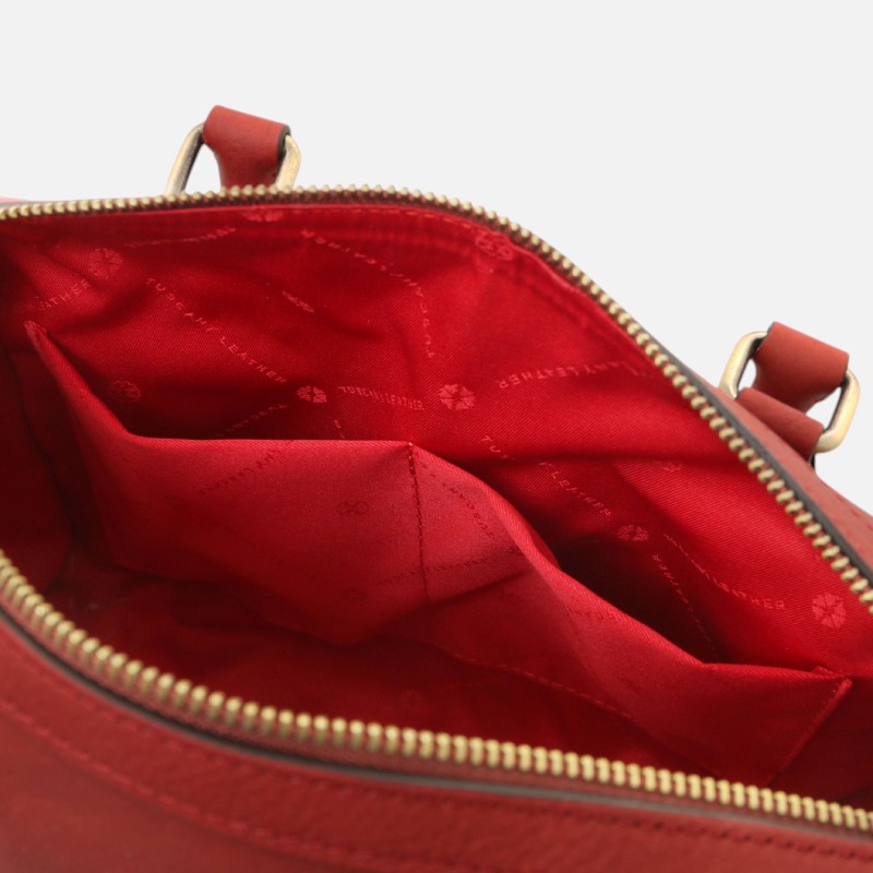 Red purse opened to show red fabric interior with multiple pockets and a gold zipper edge