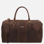 Brown leather duffel bag with top handles and a detachable shoulder strap, metal hardware, and a luggage tag.