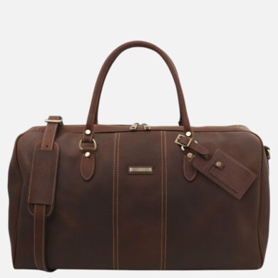 Brown leather duffel bag with top handles and a detachable shoulder strap, metal hardware, and a luggage tag.