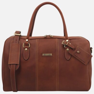 Brown leather briefcase with two top handles, brass hardware, and beige stitching; features a luggage tag and small front plaque.