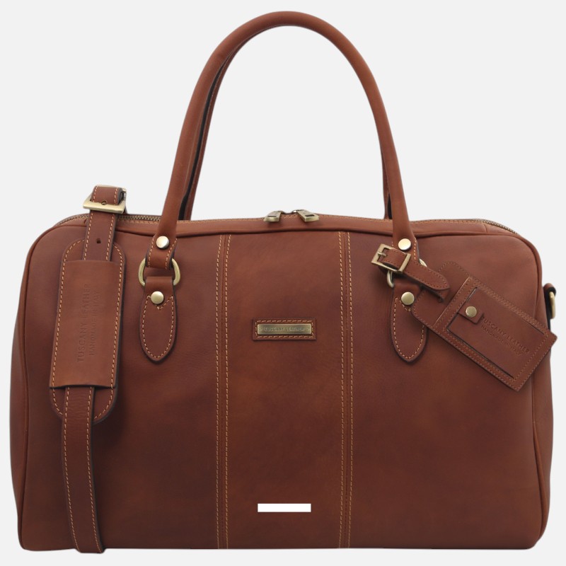 Brown leather duffel bag with top handles, shoulder strap, and brass hardware; front brand tag visible.